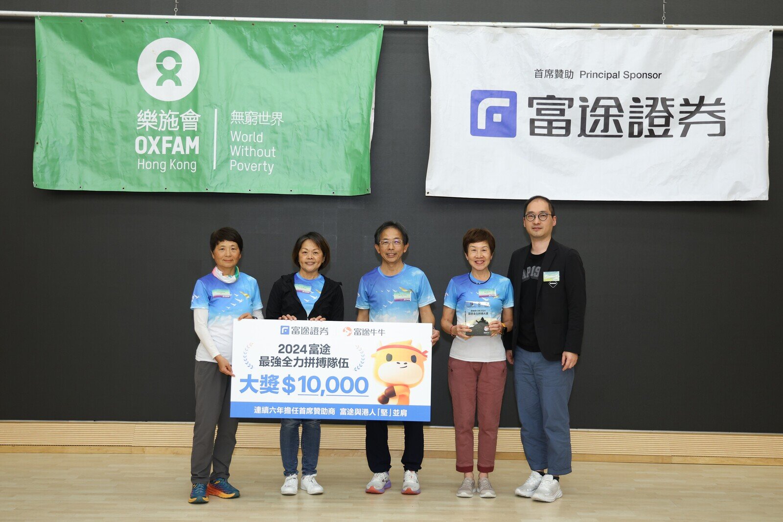 富途證券國際(香港)有限公司董事總經理謝志堅頒發樂施毅行者2024「富途證券全力拼搏大獎」予得獎隊伍。